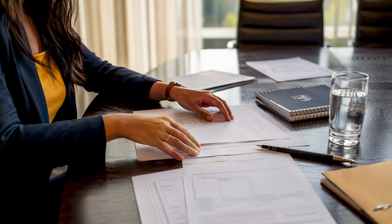 Hands arranging transfer pricing documents
