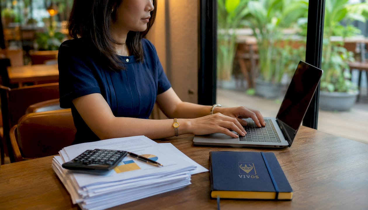 Accountant typing laptop for group audit exemption