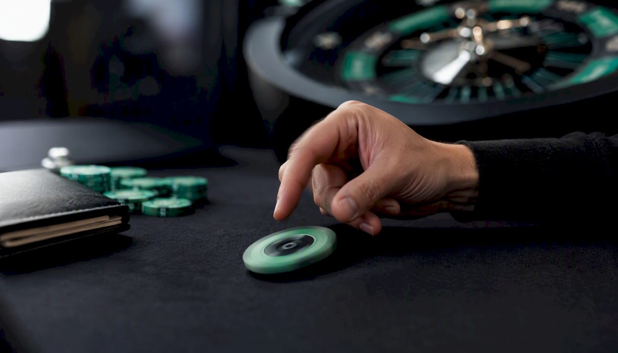 Hand spinning stake wheel token on table