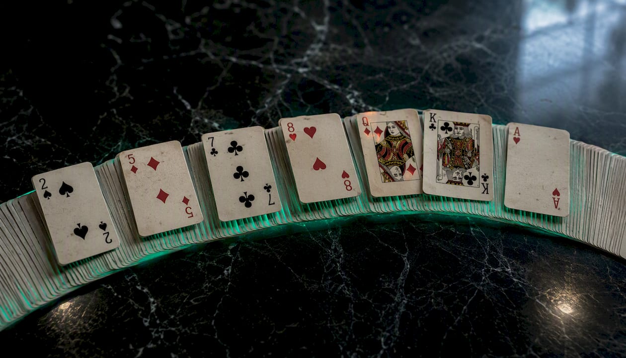 Spread playing cards with specific ranks highlighted