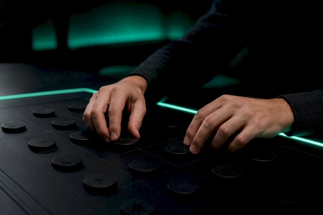 Hands assessing mines and safe tokens on gaming table