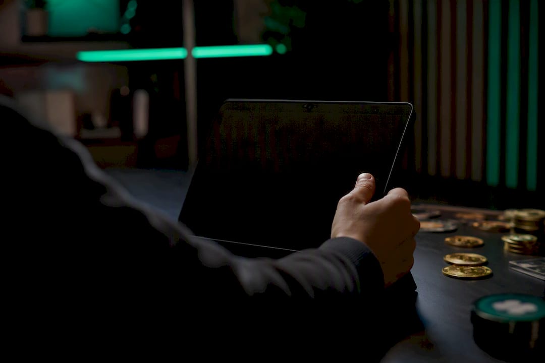 Hand interacting with tablet in dark setting