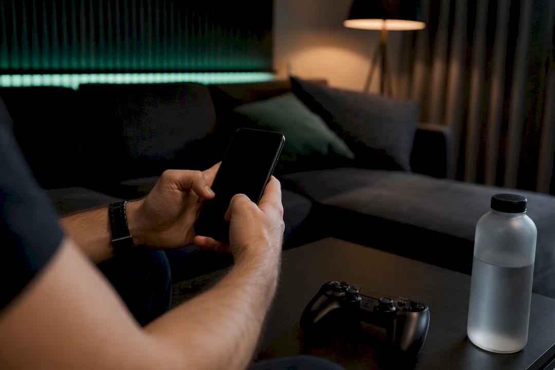 Hands holding smartphone ready to view bet replay