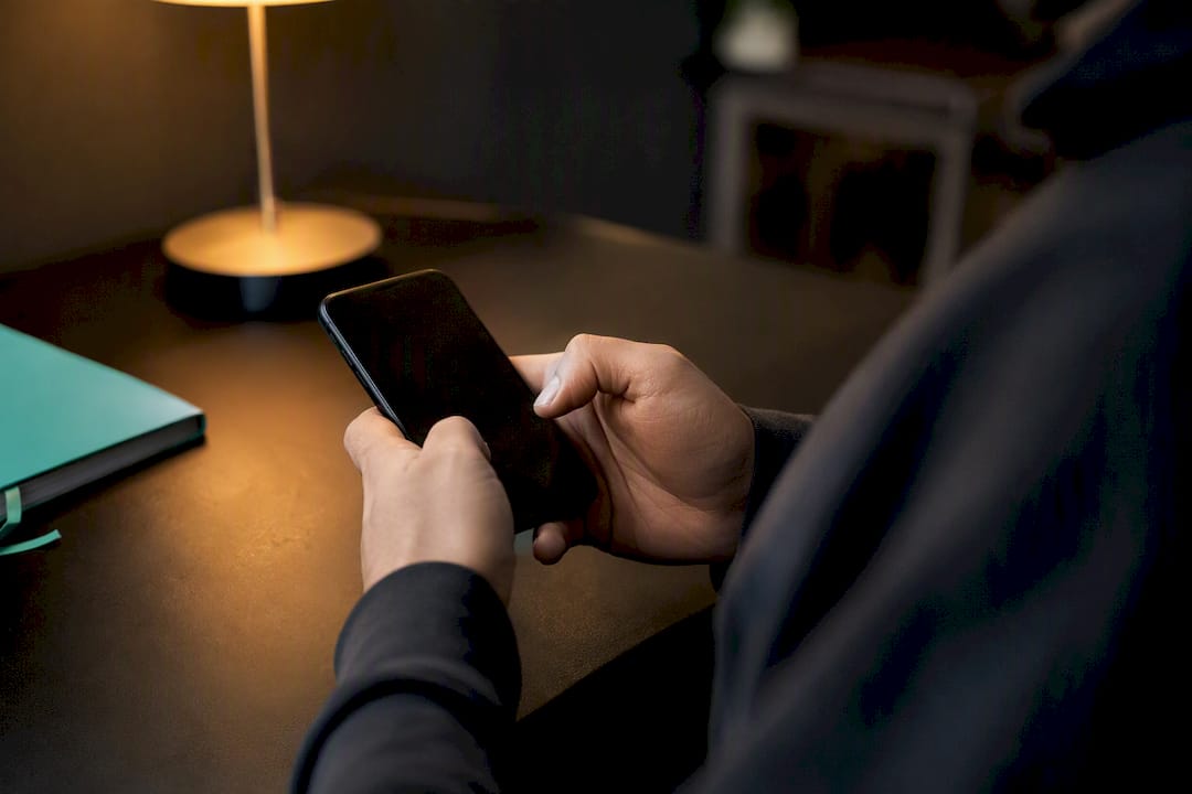 Hands holding smartphone verifying bets