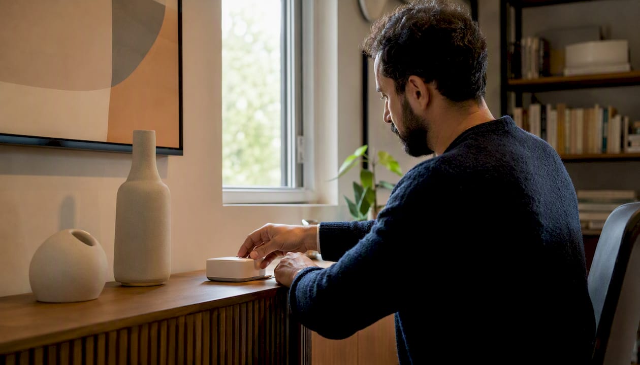 Hands setting up home automation device