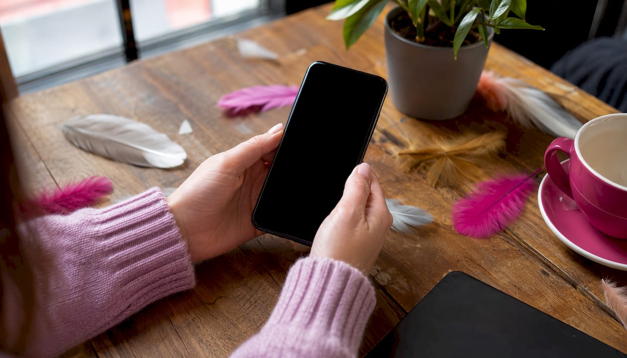 Hands holding smartphone for accessibility testing