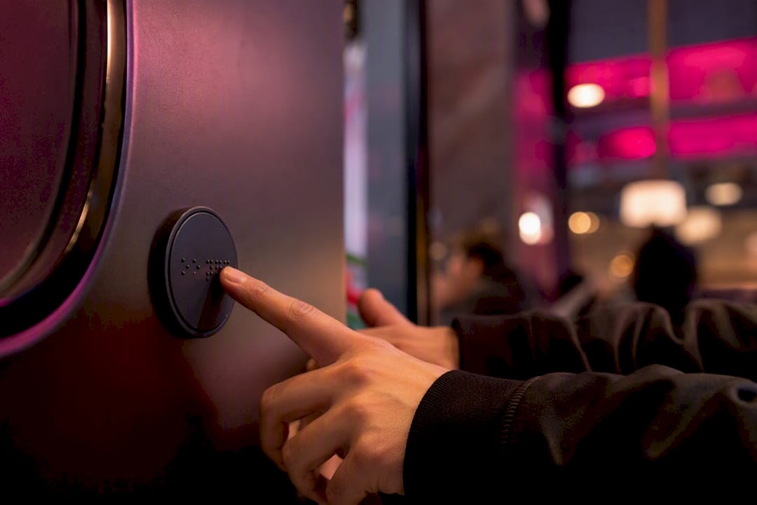 Hands pressing button on tactile interface