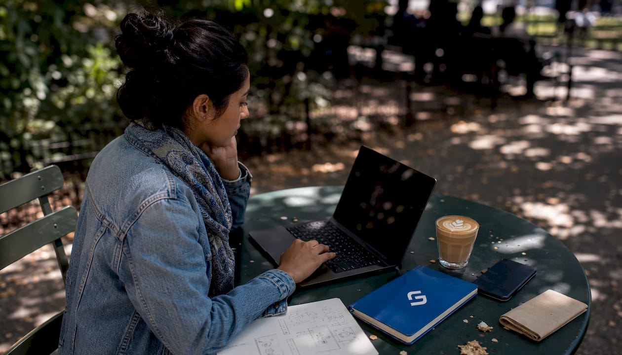 Woman working on brand marketing notes at café