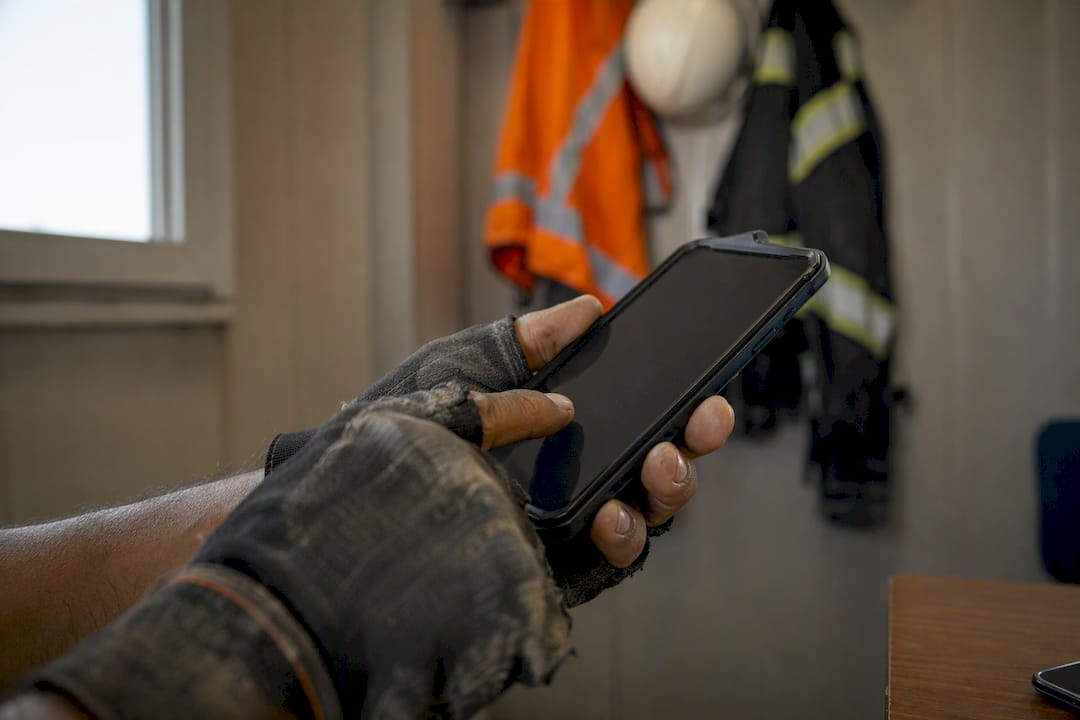 Hands digitally signing safety meeting attendance on site