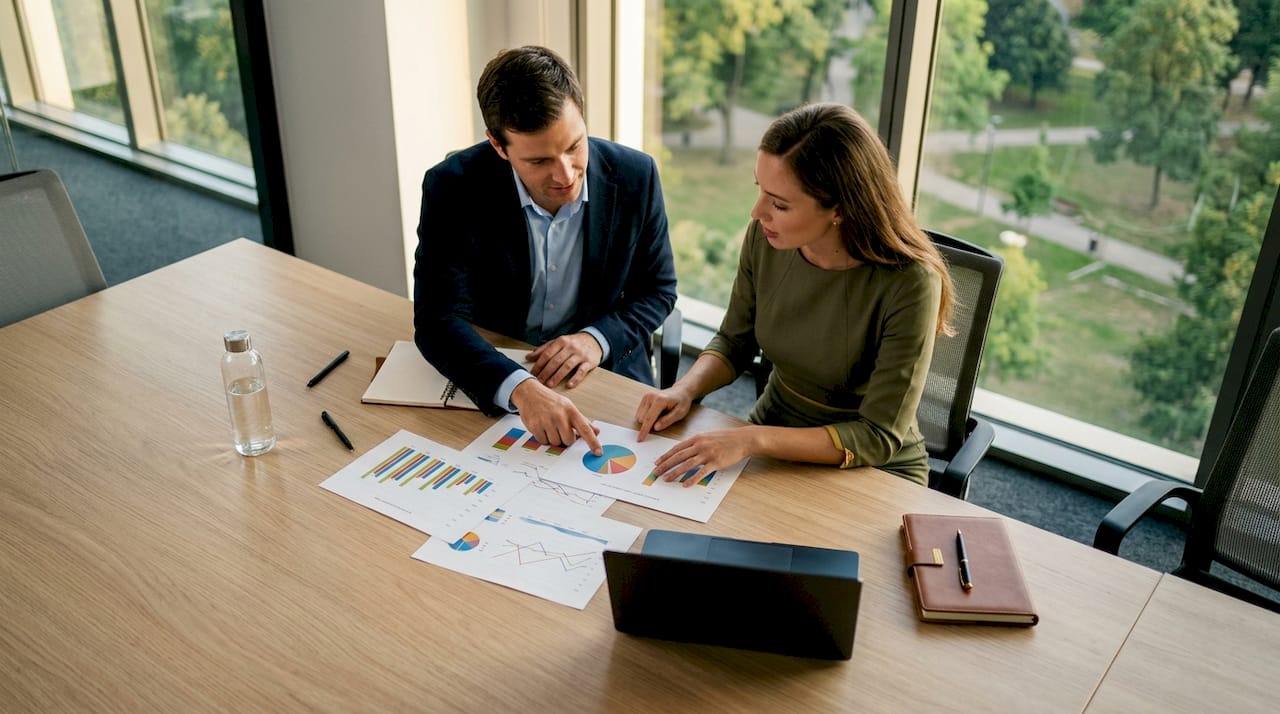 Two professionals discussing market valuation methods