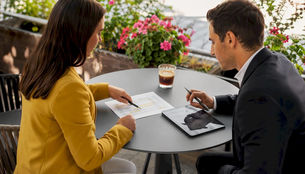 Hands pointing at due diligence checklist document