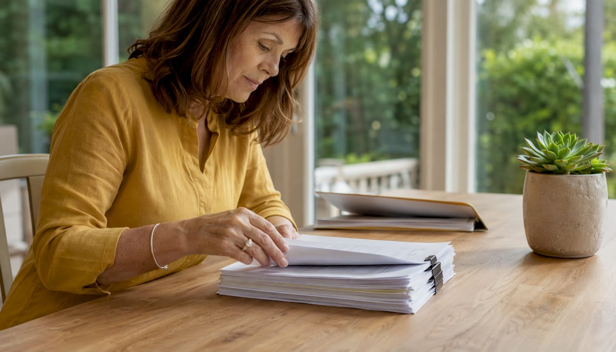 Hands organizing financial documents