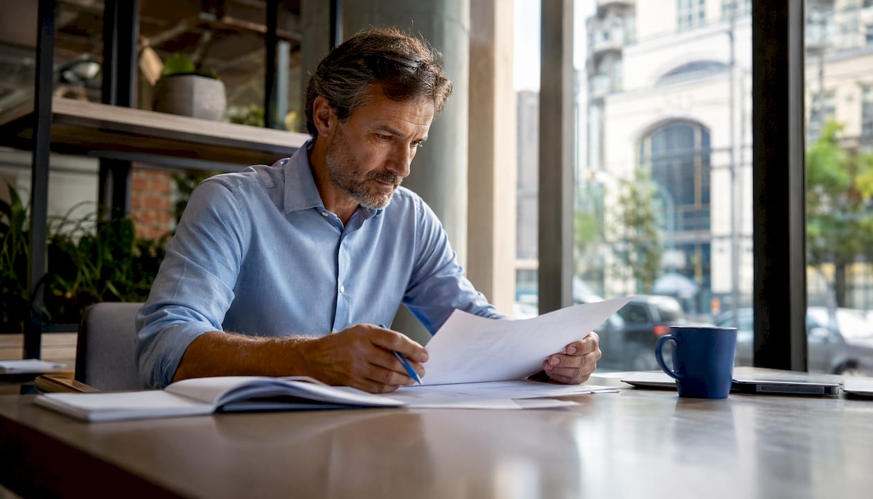 Business owner reviewing cleaning service contracts