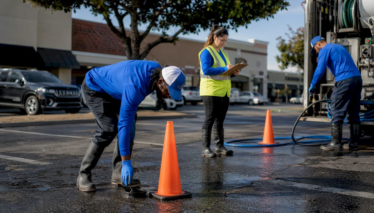 Pressure washing crew preparing parking lot service