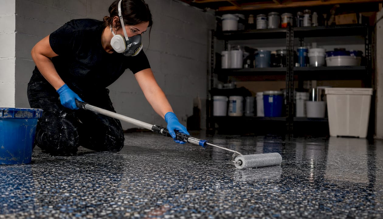 Installer rolling clear topcoat on epoxy floor
