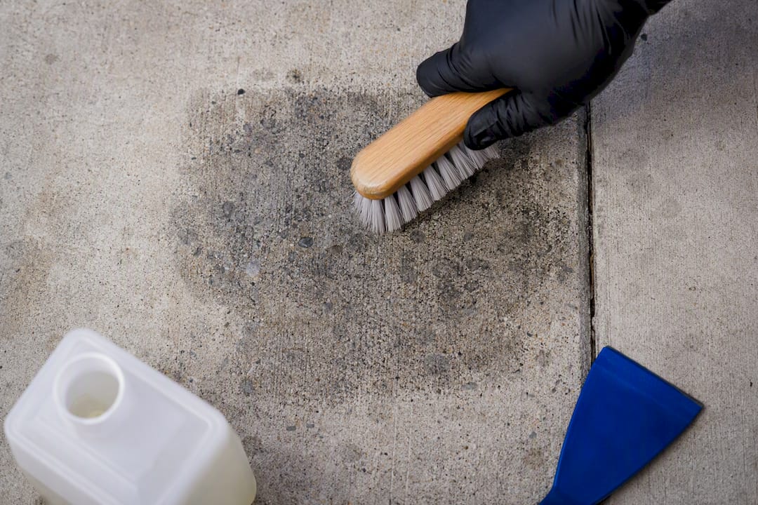 Scrubbing black gum residue from concrete