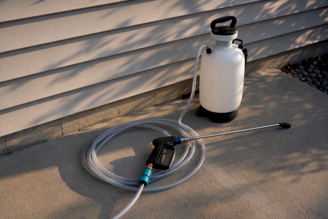 Low-pressure soft-wash equipment beside siding