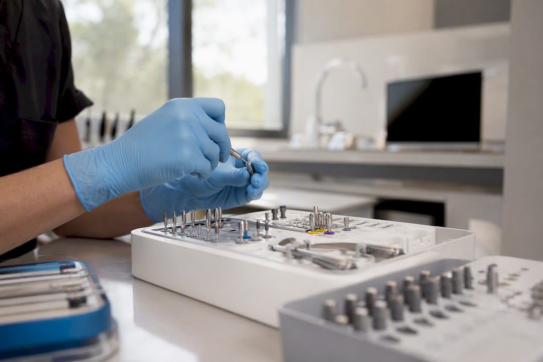 Hands assembling dental implant surgical kit