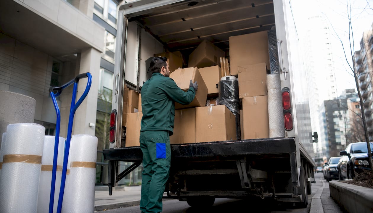 Mover loading boxes into truck outdoors