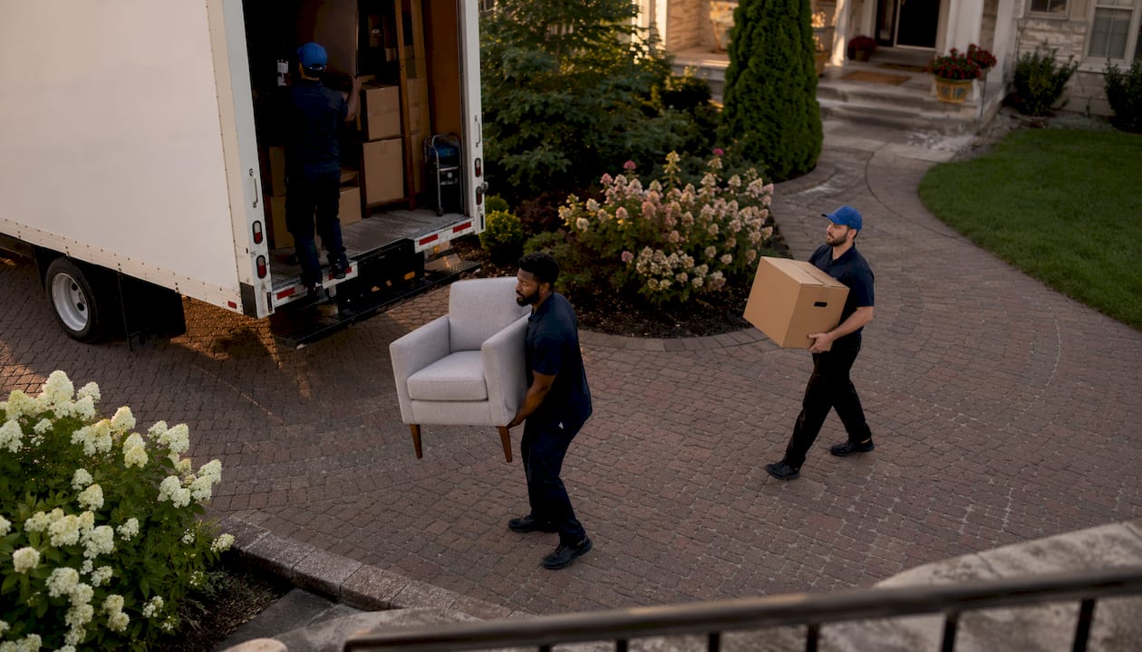 Movers unloading furniture from truck