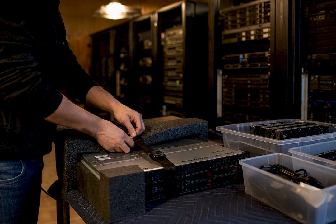 Hands packing servers with anti-static foam
