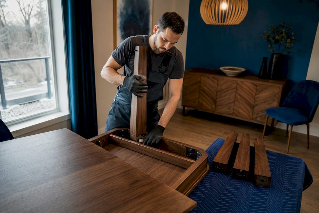 Mover disassembling dining table for relocation