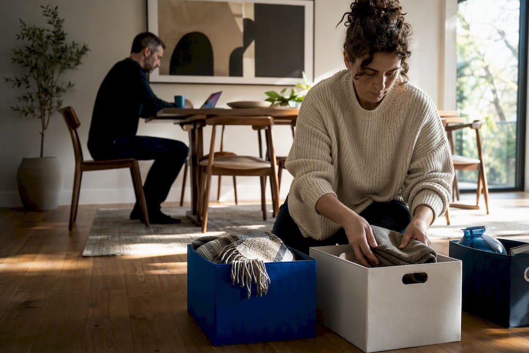 Two adults quietly decluttering together
