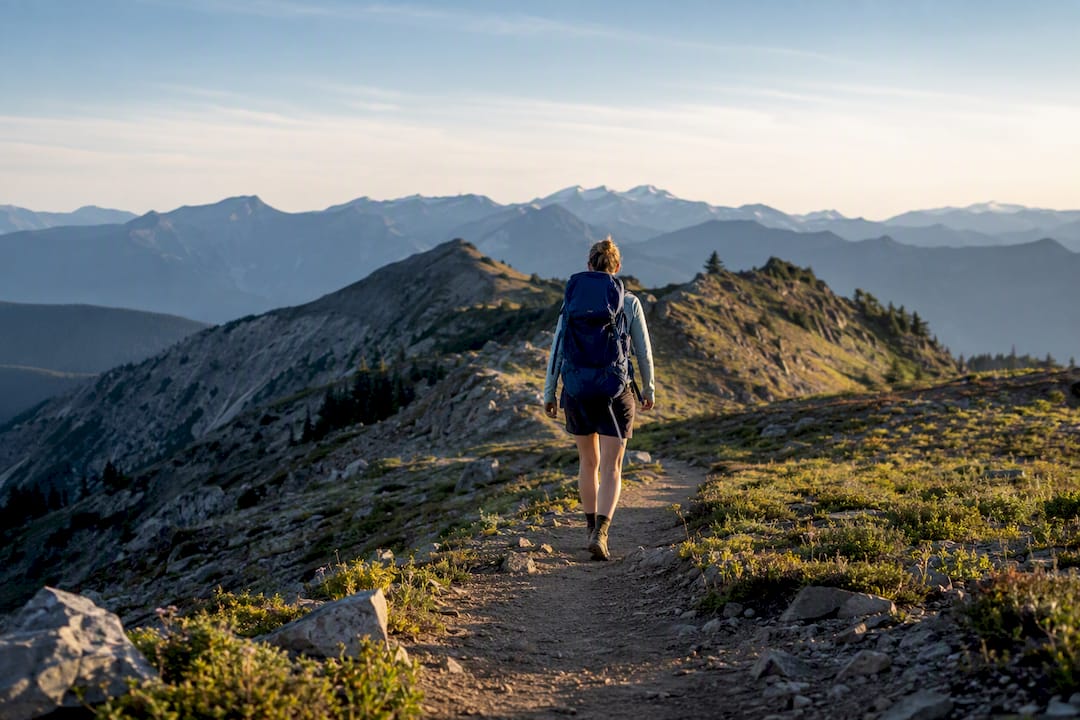 Solo hiker walking a Pacific Crest Trail ridgeline
