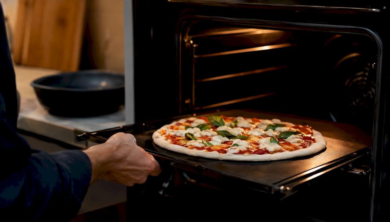 Neapolitan pizza on baking steel inside home oven