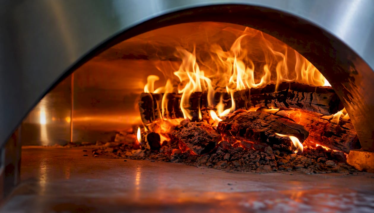 Flames burning inside wood pizza oven