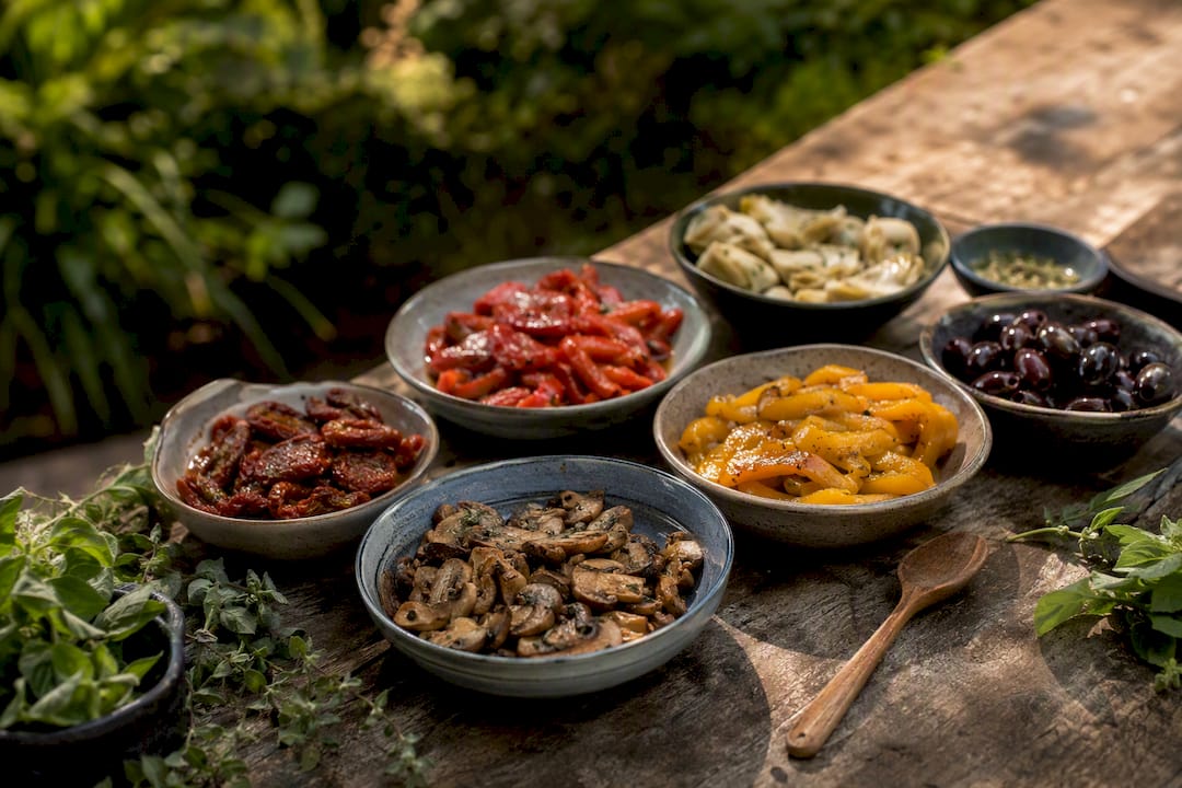 Bowls of roasted vegetarian pizza toppings