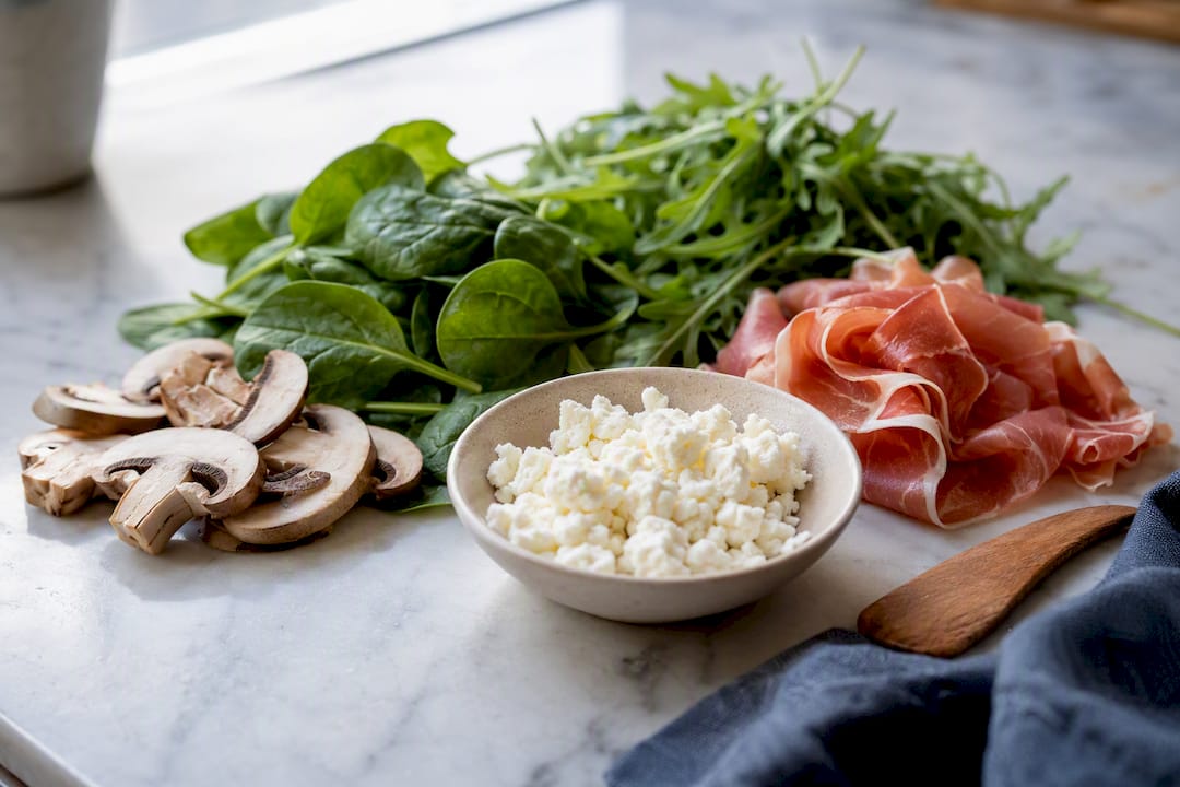 Goat cheese with mushrooms greens and prosciutto