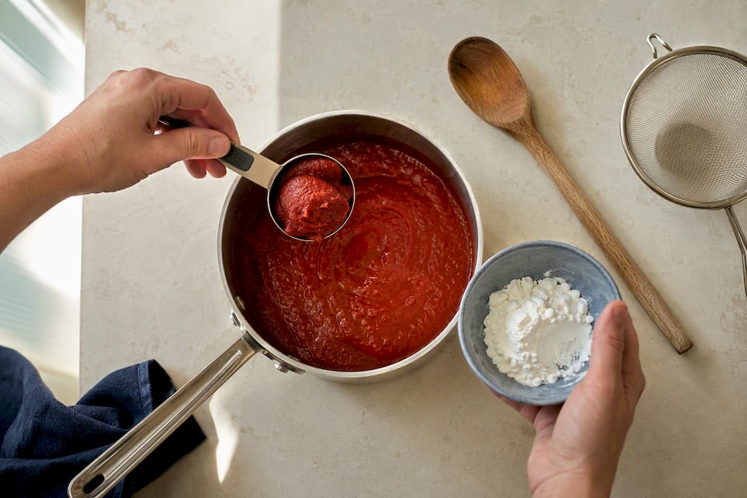 Tomato paste and cornstarch beside sauce