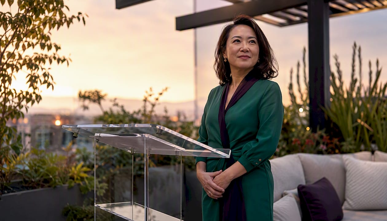Woman leader composed at podium under pressure