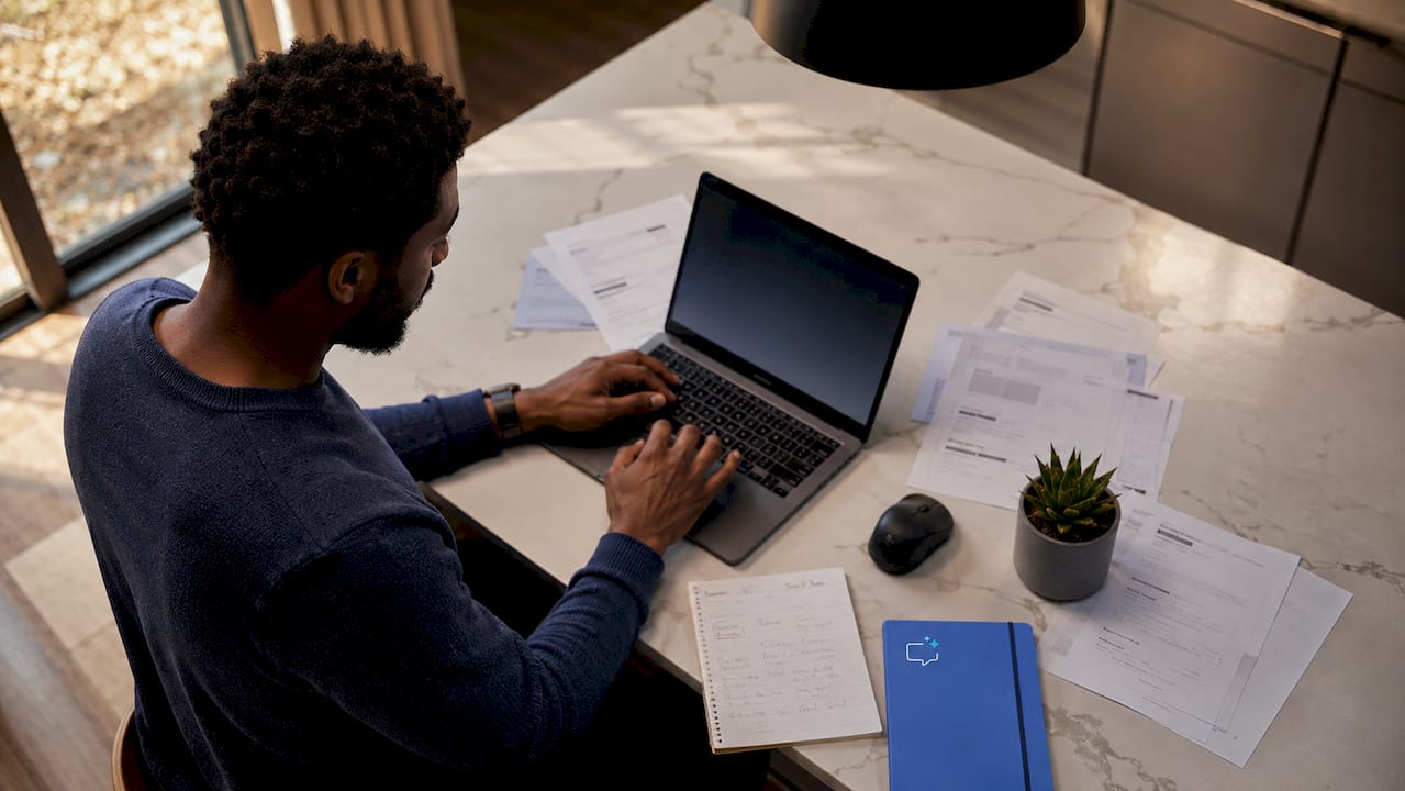 Hands customizing invoice reminders on laptop