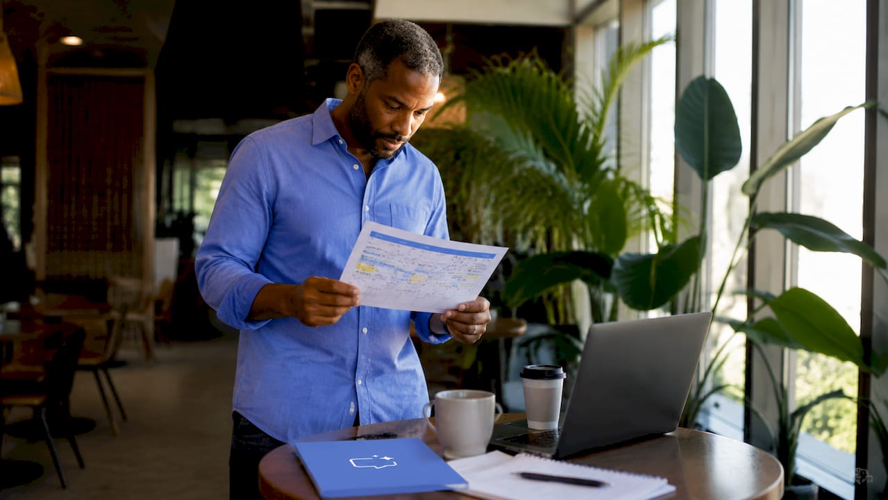 Manager reviewing AI employee schedule printout