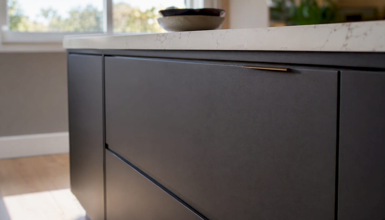 Close-up of modern slab cabinet door with hardware
