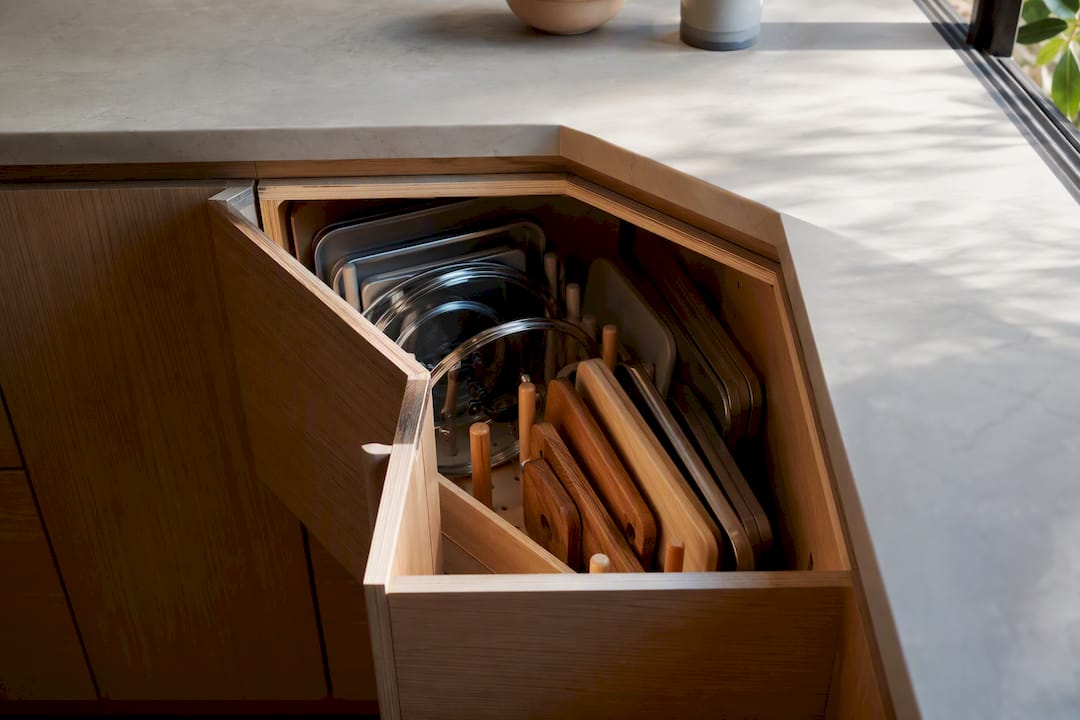Open corner cabinet drawer with organized storage