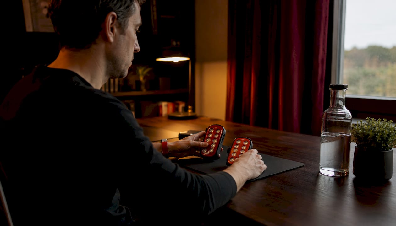 Hands comparing home red light therapy devices