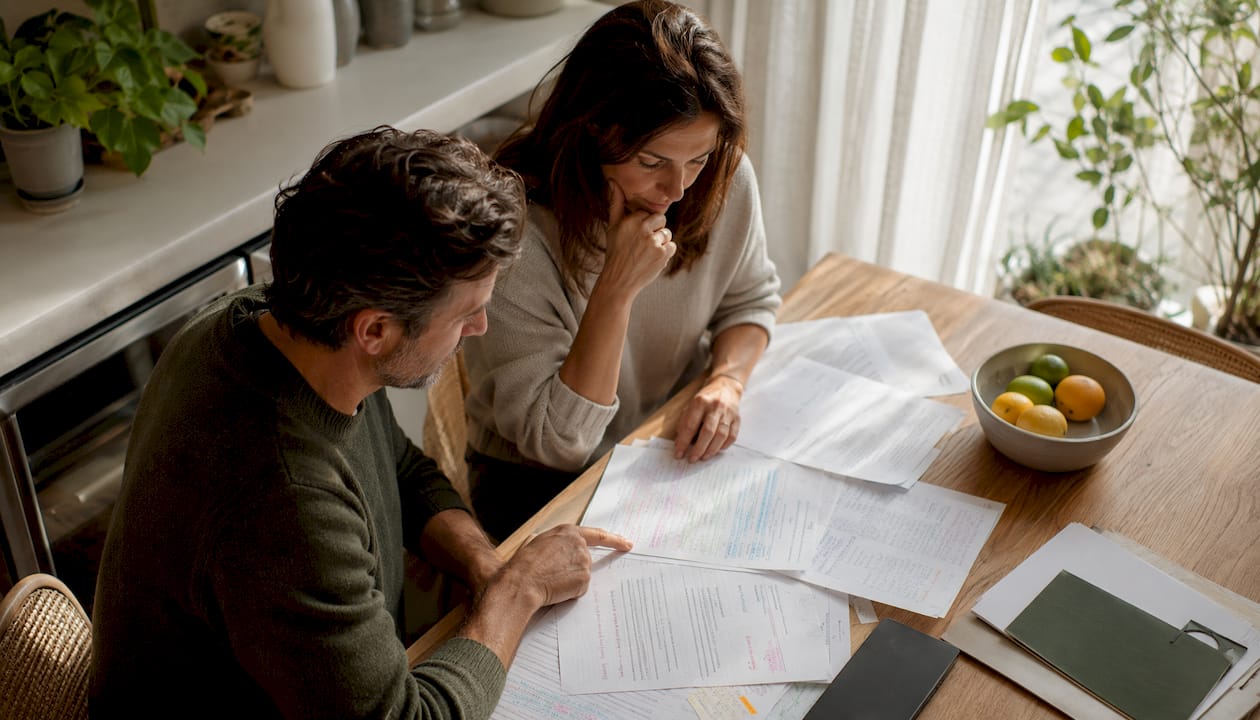 Couple reviewing prenuptial agreement documents