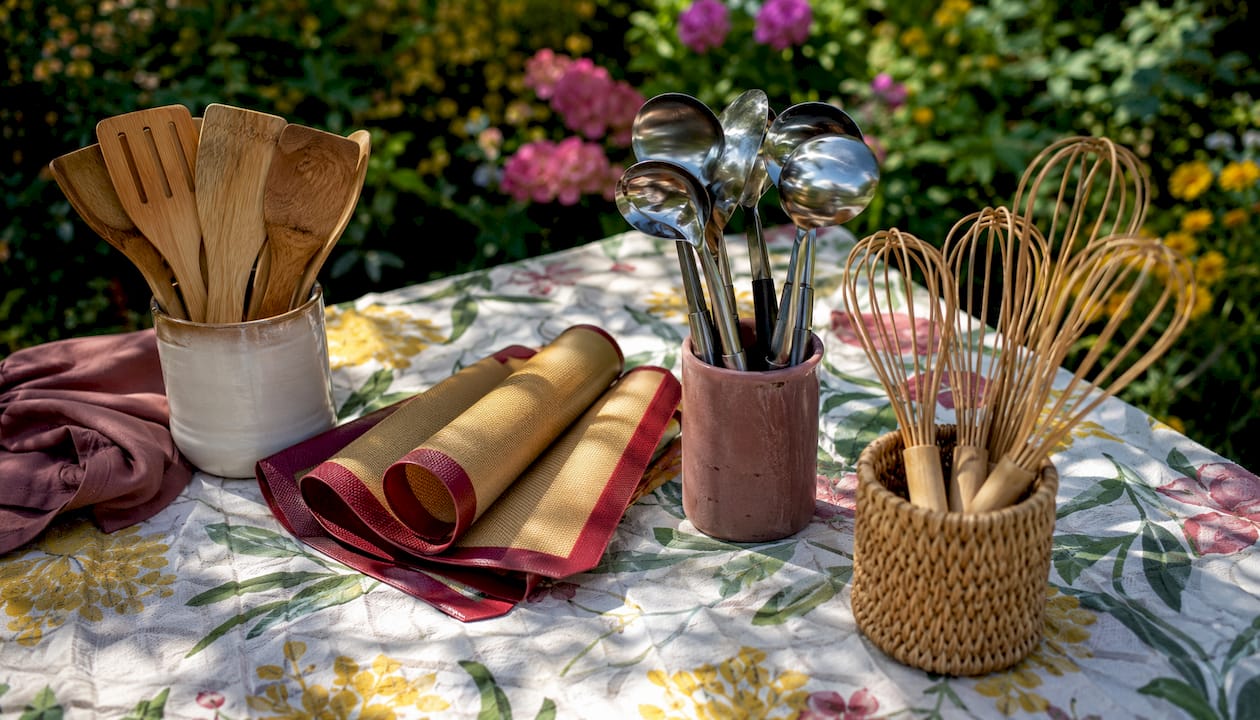 Overhead view of assorted cooking utensils arranged by type