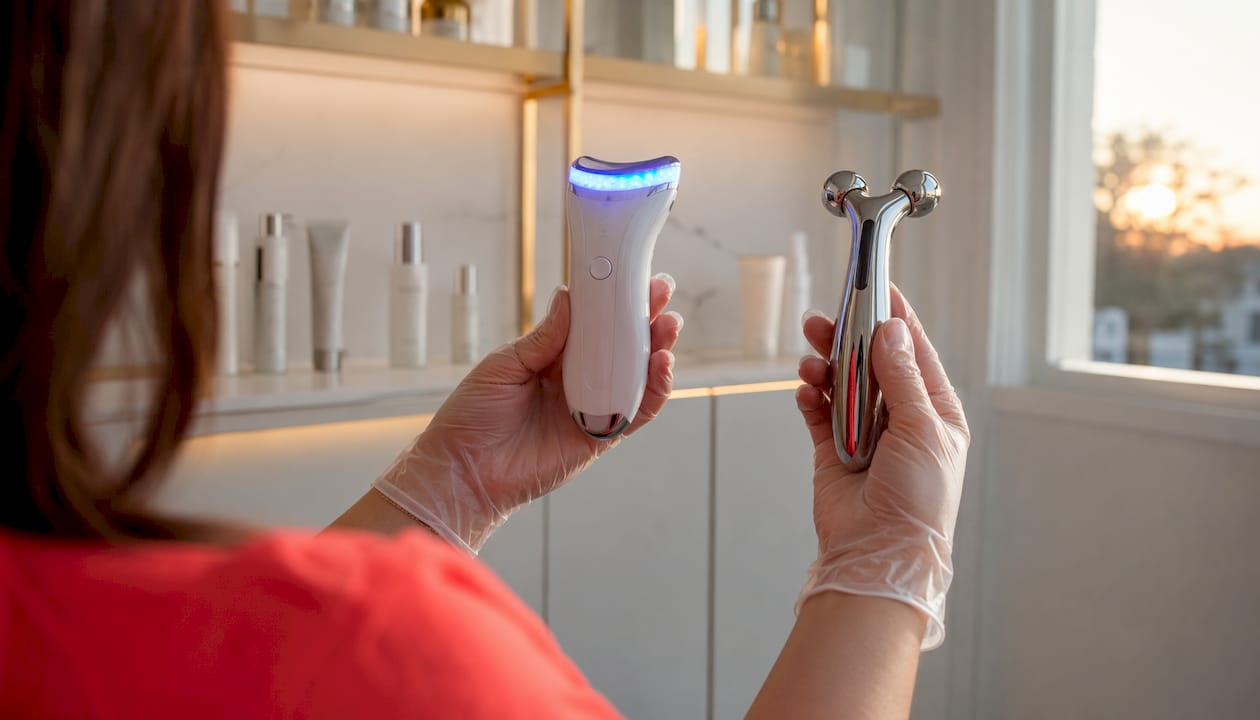 Dermatologist hands holding microcurrent and LED devices
