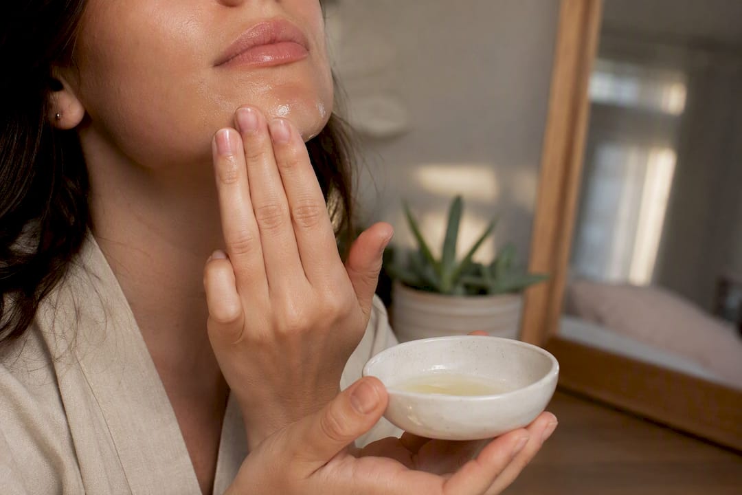 Applying retinoid serum to marionette line area