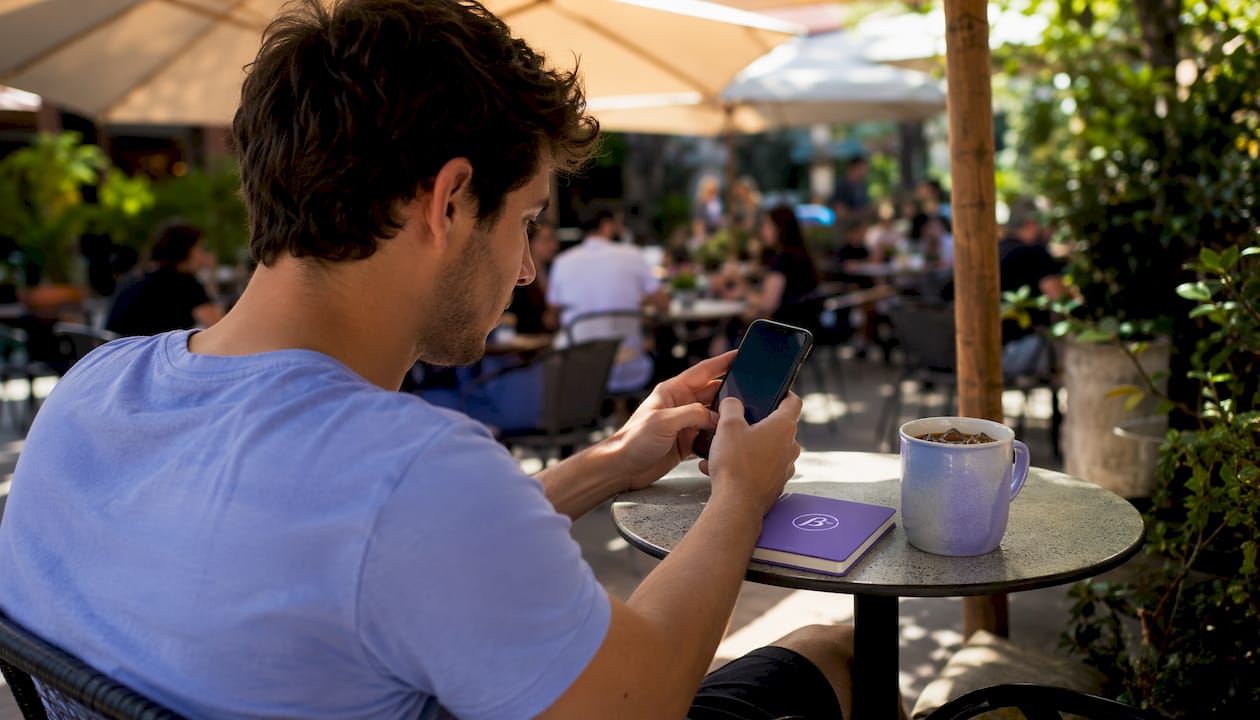 Young man logging mood quickly on smartphone