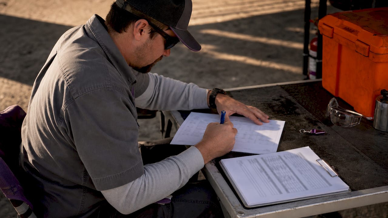 Close-up hands filling hazard assessment form