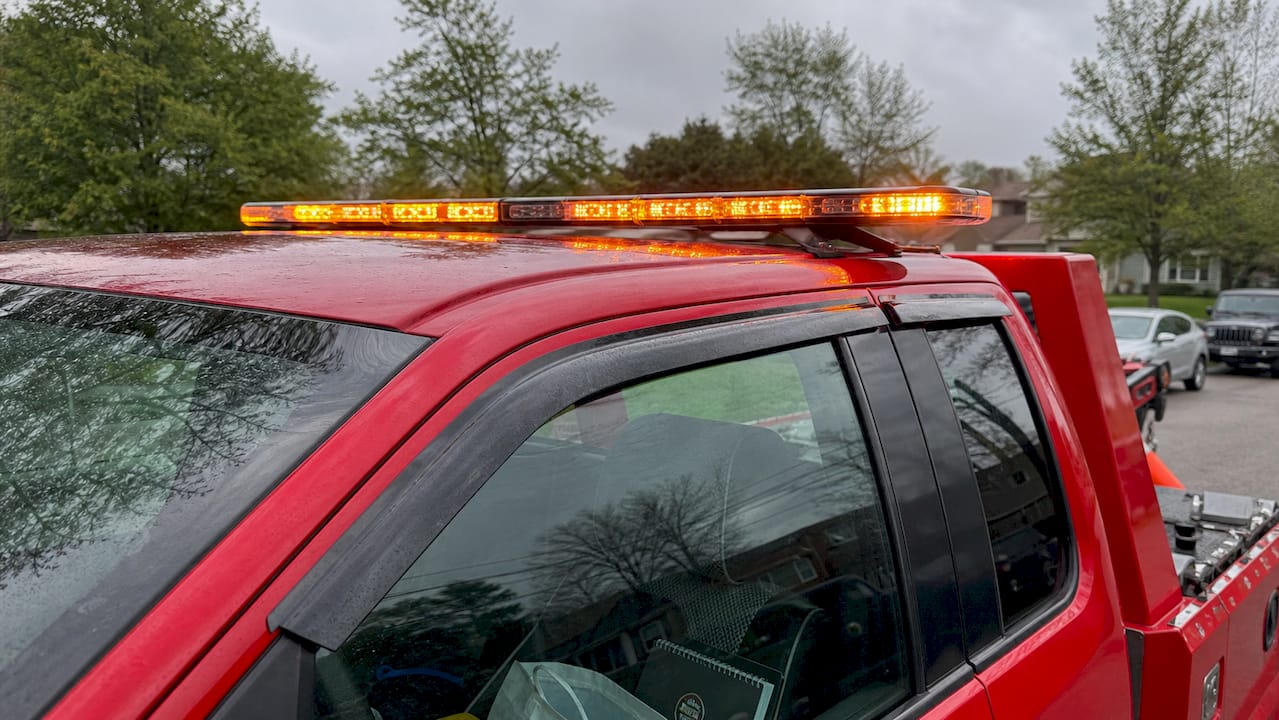 Close-up of amber tow truck light bar flashing