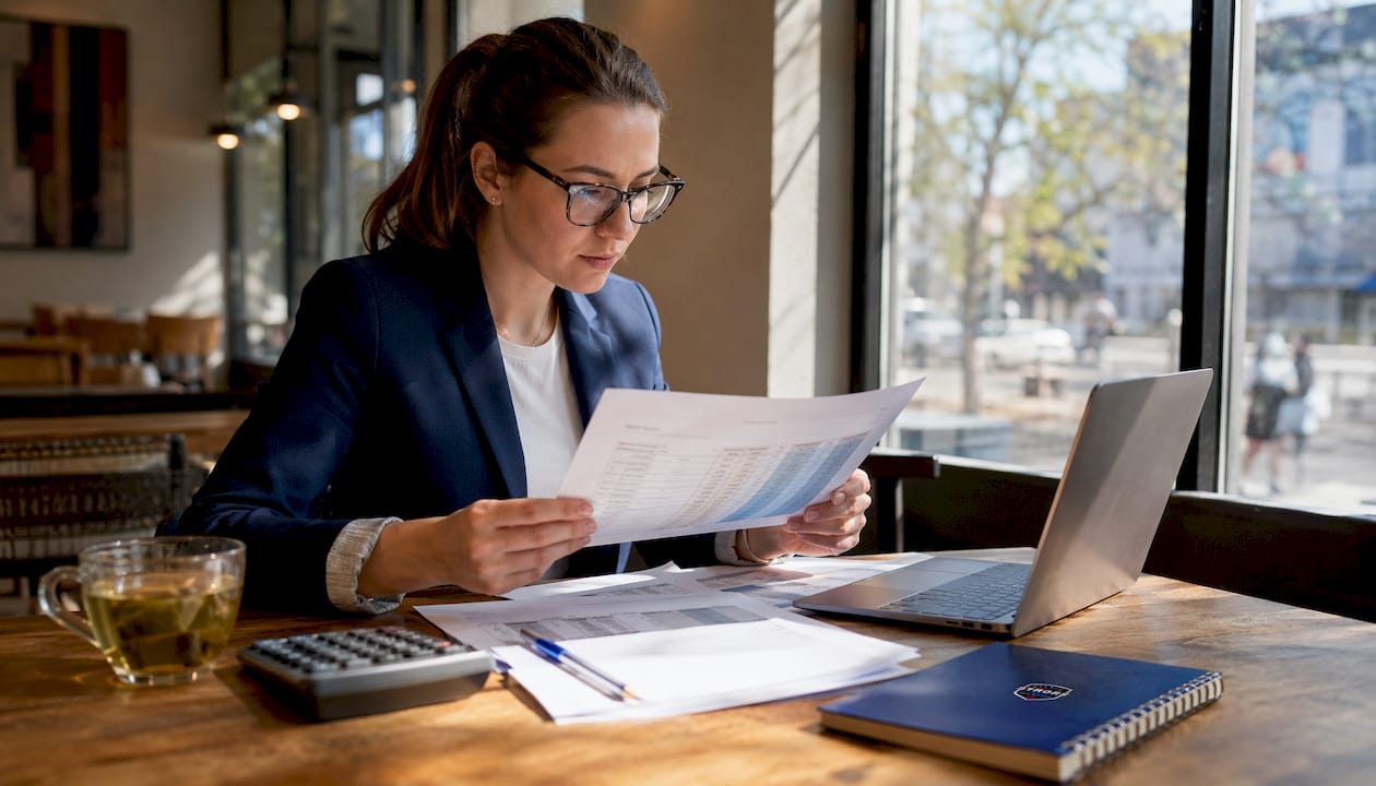 Woman reviewing fleet maintenance cost sheets