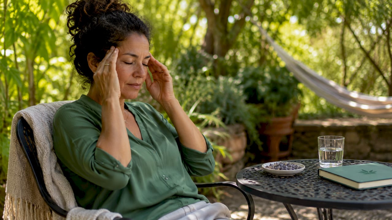 Woman relieving tension headache at home