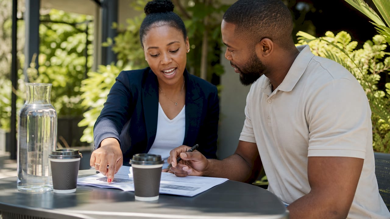 Two professionals discussing solar loan options