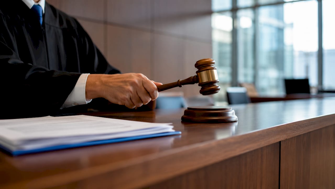 Judge's hand with gavel in courtroom